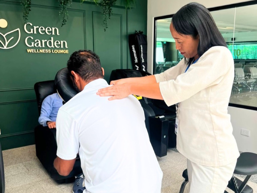 Therapist giving a back massage on an ergonomic chair